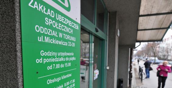 Na zdjęciu tablica informacyjna z napisem Zakład Ubezpieczeń Społecznych Oddział w Toruniu 