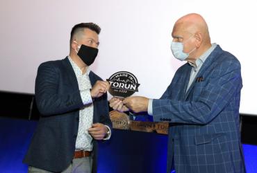 Przedstawiciele nowego laureata znaku uroczyście odbierają certyfikat na scenie